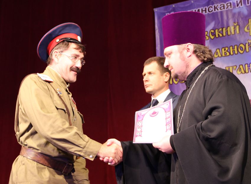 В.Ю. Гречишников и отец Сергий награждают участников.